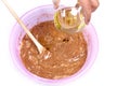 Add vegetable oil to the muffin batter - membuat adonan kue Royalty Free Stock Photo